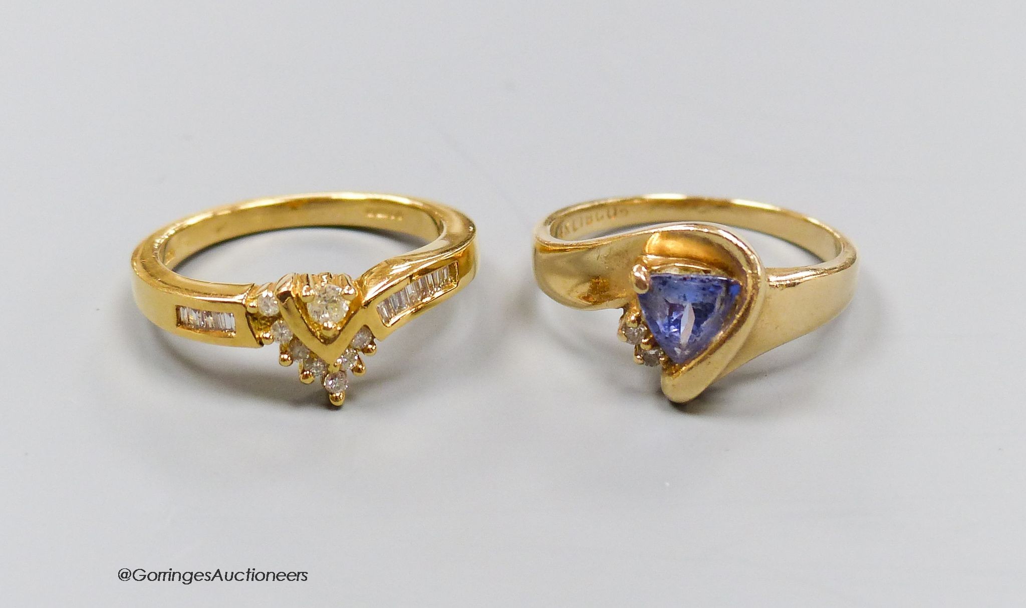 An 18ct gold and diamond dress ring, size N, gross 4.5g, and a 14k gold, diamond and tanzanite ring, size N, gross 3.7g.